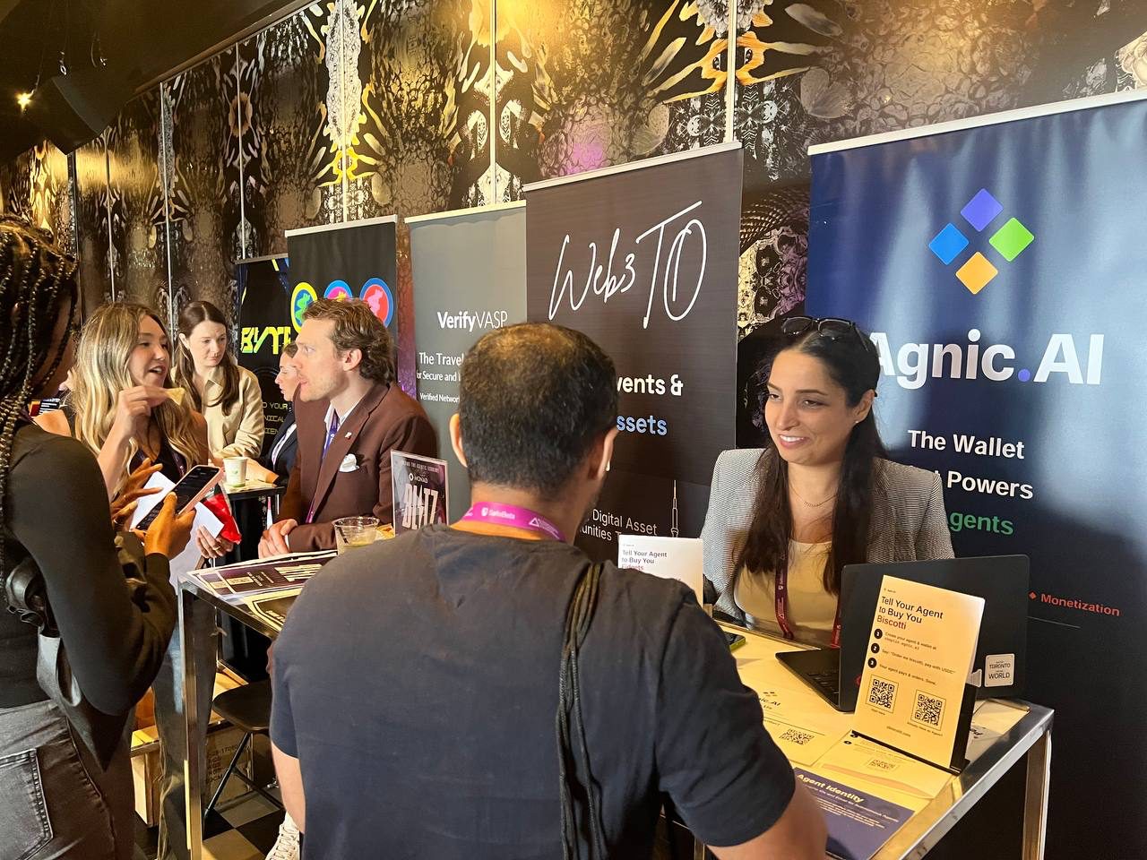 Attendees gathered around the shared Agnic and Obiscotti booth