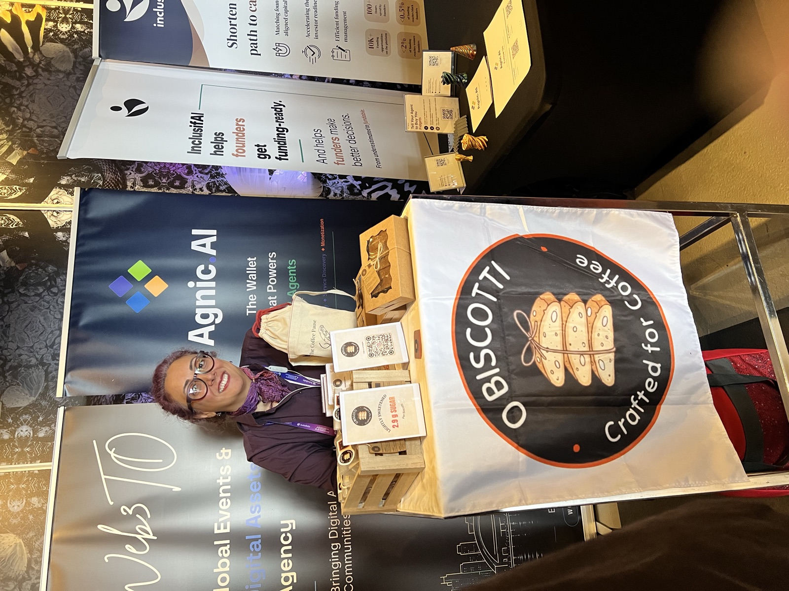 Obiscotti founder at the shared Agnic and Obiscotti booth, with biscotti packaging on the table