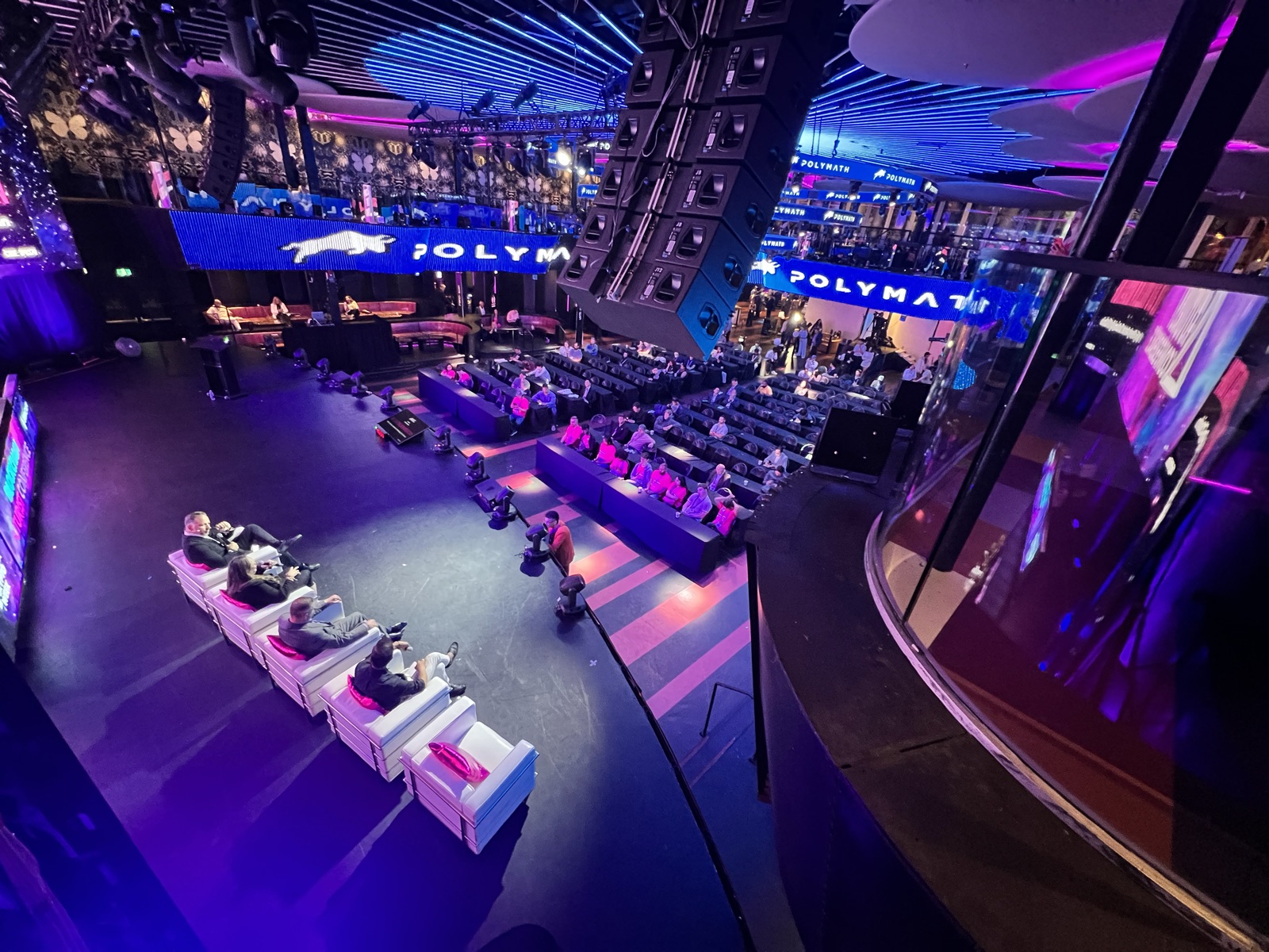 Wide interior shot of the Blockchain Futurist Conference venue with the Polymath stage and audience seating