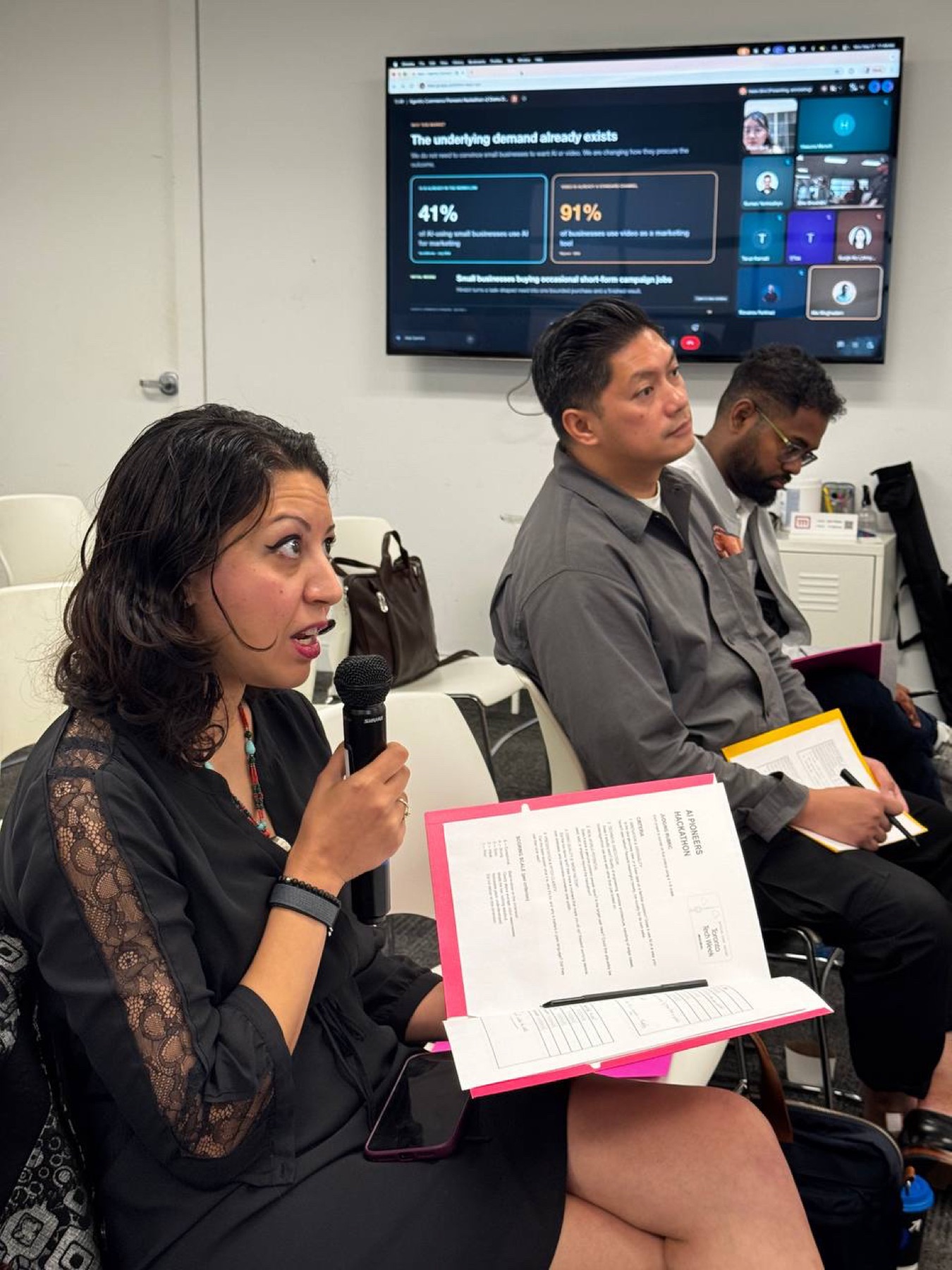 Judges reviewing a remote presentation and asking questions at Demo Day
